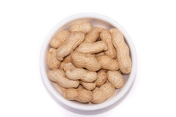 Peanuts in a white cup on a white background