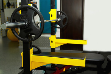 Gym. Gymnasium with sports equipment. Barbells, dumbbells - equipment to work on muscle mass. Fitness club weight training equipment gym. Barbell ready to workout, indoors, shallow.