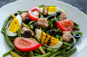 Warm salad with green beans, tuna, tomatoes and boiled eggs