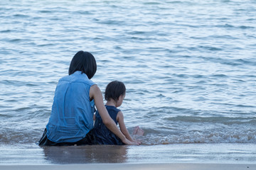 mum and kid on the beach