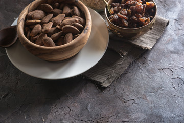 Almond with raisins in a dish of wood