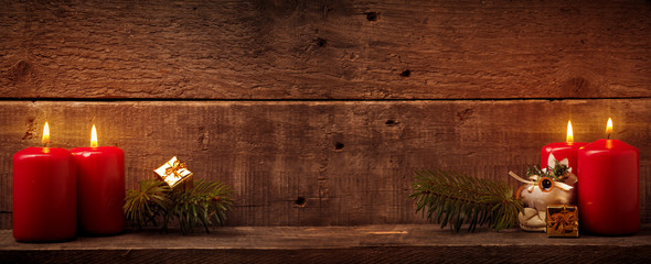 Vierter Advent, Rote Kerzen auf rustikalem Holzhinterung mit Textraum