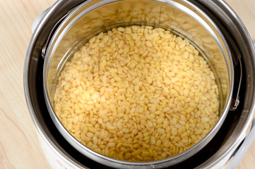 mung bean in electric pot on wooden table