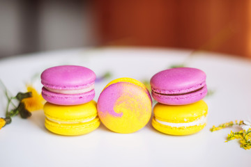 Symbol heart of flowers and macaroons on the light background. Top view. Text I love you