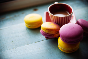 Gentle colorful macaroons on color wooden background