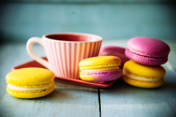 Gentle colorful macaroons on color wooden background