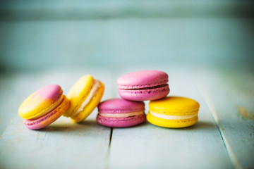 Gentle colorful macaroons on color wooden background