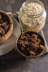 Almond with raisins in a dish of wood