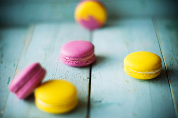 Group of pastel color macaroons on blue textured shabby chic background, with room for copy space