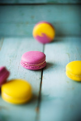 Group of pastel color macaroons on blue textured shabby chic background, with room for copy space