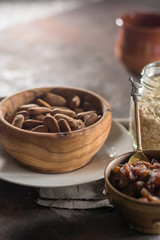Almond with raisins in a dish of wood