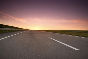 Empty highway with the rising sun
