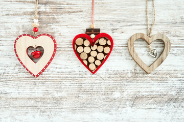 Christmas background. Three Christmas hearts on wooden background. Copy space
