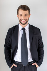 Young man wearing a suit and smiling