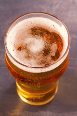 Beer on gray wooden background, wiew from above