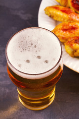 Beer and chicken wings buffalo with cheese dip. View from above, top studio shot, vertical