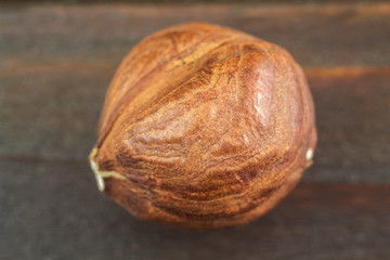 Raw brown hazelnut on wooden planks, macro image, top view