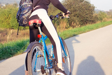 Naklejka premium Girl with Bicycle on nature background