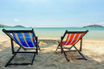 Beach chairs on the white sand beach and tropical sea