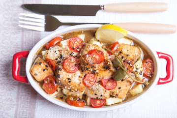 Salmon baked with sesame, tomatoes and zucchini. Close-up. Selective focus.