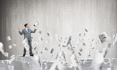 Businessman standing with megaphone.