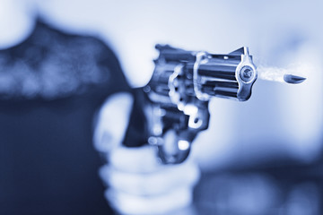 hand gun pistol in a woman hand
