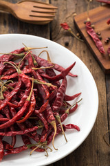 Red Dried Chillies or Dry chillies on wood
