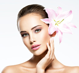 Beauty pure face of the young beautiful girl with flower