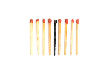 burned with new wooden match sticks on white background. Different Concept