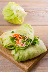 Lettuce wraps with chicken, carrot, peanuts and ginger-scallion oil. View from above, top, vertical