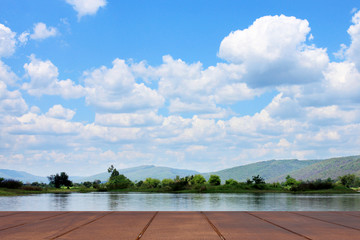 Wooden floor with river of morntain and blue sky