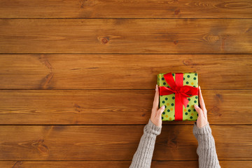 Fototapeta na wymiar Christmas gift on brown wood background