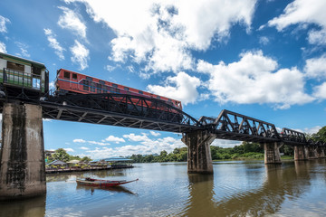 Low angle train running on histotic railway of River Kwai bridge at Kanchanaburi