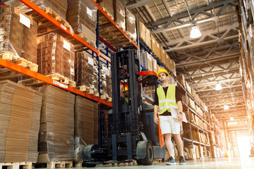 Workers using technology forklift in warehouse