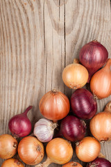 vegetables crop  on wooden background onions garlic, top view, copy space