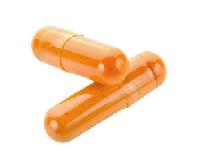 Turmeric capsules isolated on white background.
