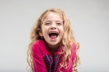 Laughing schoolgirl with curly hair