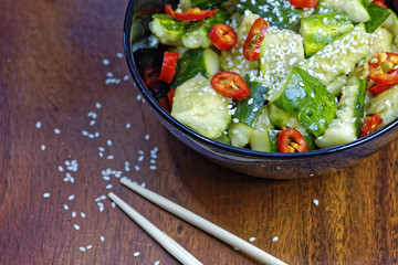 Close up of chinese broken cucumbers with sesame oil, pepper and garlic