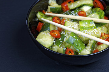 Close up of chinese broken cucumbers with sesame oil, pepper and garlic