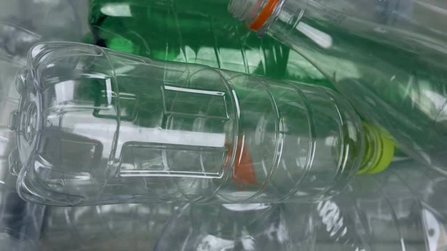 Plastic recycle bottles, tracking shot, camera looking down