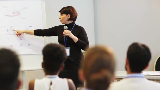 speaker with microphone at business conference
