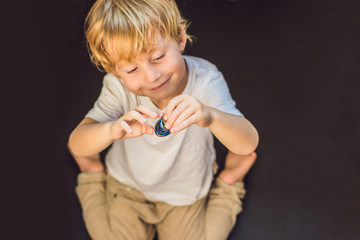 Young boy play with fidget spinner stress relieving toy