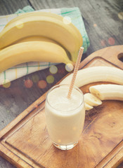 Banana smoothie on a rustic wooden table