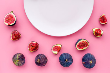 Empty plate among fresh blue figs on pink background top view mockup