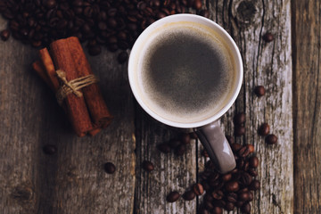 coffee cup with coffee beans on wood background