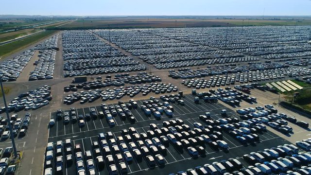 Aerial Shot of the Gigantic Car Distribution Parking Lot. With Fields in the Background.Shot on a Camera in 4K (UHD).
