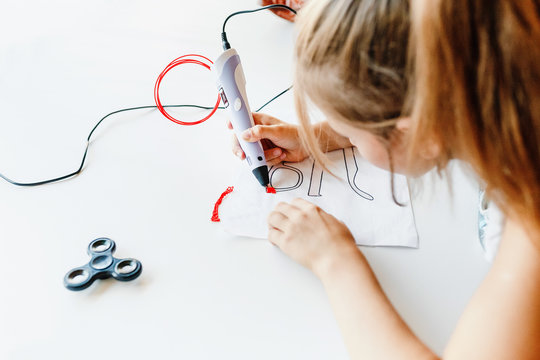 girl using 3D printing pen, education concept
