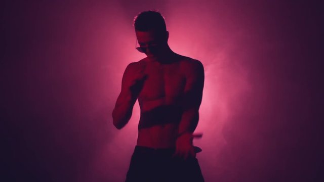 Silhouette of a man dance in smoke