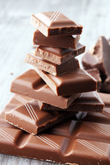 Dark Chocolate chunks and stacked broken chocolate bar.