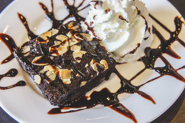 brownie cake and creamy dessert on white dish